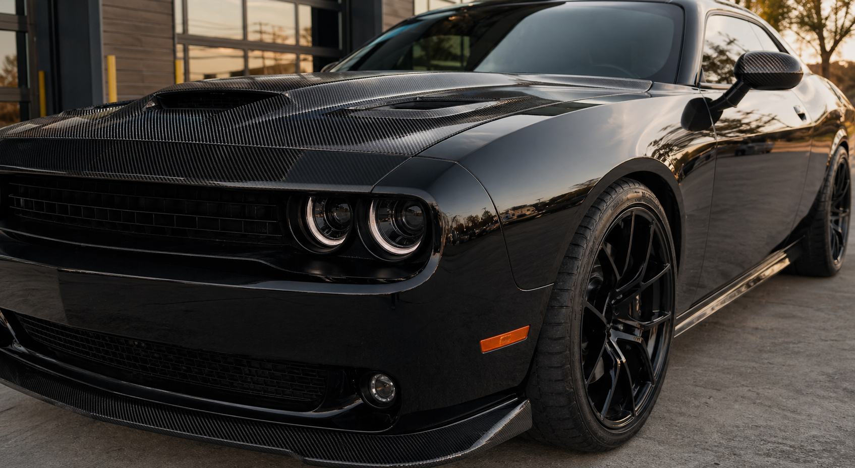 Installed carbon fiber detail on a black performance car